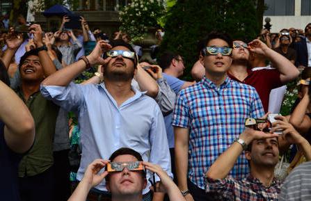 Crowd of people wearing eclipse glasses